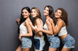 © F8  \ Suport Ukraine - Four attractive women in white shirts and shorts embracing isolated on grey background