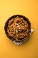 Canvas Print - Wheat flour Halwa or Shira or porridge /  Atte ka Halva, Popular healthy dessert or breakfast menu from India. served in a bowl or plate. selective focus