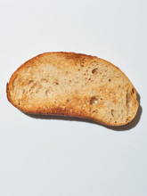 Slice Of Sourdough On White Surface