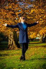 Wall Mural - middle-aged woman walking in city park