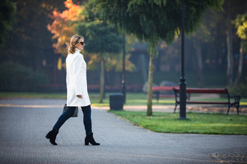 Wall Mural - middle-aged woman walking in city park