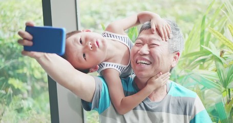 Wall Mural - grandfather take selfie with grandson