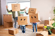 © didesign - Happy family throwing a party with boxes on their heads