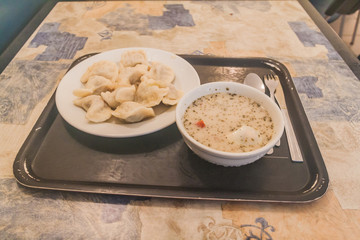 Polish food in local fast food eatery. Pierogi and zureg soup.