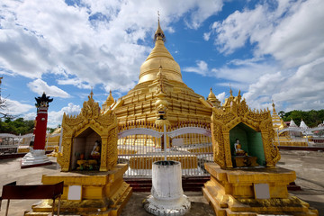 Wall Mural - Wide angle of magnificent golden Kuthodaw Pagoda under sunny blue sky white clouds in Mandalay Myanmar