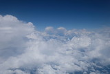 Fototapeta Niebo - aerial view of white clouds in gradient blue sky. Flying over the clouds