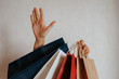 © Iuliia Pilipeichenko - Happy woman holding in hand shopping package. Paper bag. Sale in store. Beautiful young girl in fashion shop. Customer buy present. Black friday sale. Holiday special offer, discount. Female in market