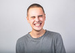 © Anastasia.photoyoga - Happy fun young man toothy laughing with wide opened mouth and closed eyes in casual clothing on blue background with empty copy space. Hapy humor teen model