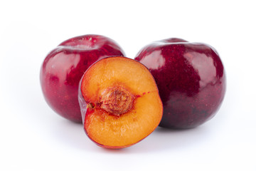 ripe red plum on white background