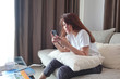 © Kenstocker - women use smartphone in house on holiday