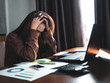 © Kenstocker - business women cover head by hand on desk, stress from hard working
