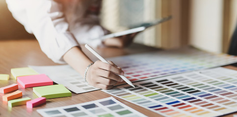 Wall Mural - young professional ui graphic designer choosing colours for their smartphones templates