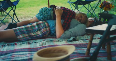 Wall Mural - Little toddler lying on his mother in a tent