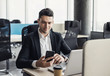 © kite_rin - Businessman working on computer. Young man professional using laptop and smart phone in the office. Management, finance, business concept