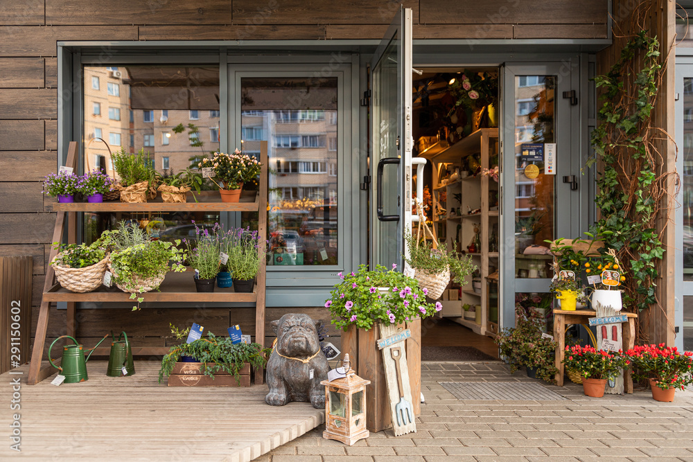 Cosy floral shop with shelves of flowers and garden decorations - obrazy, fototapety, plakaty 