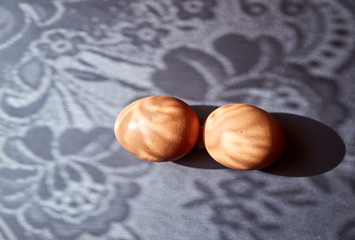 2 brown chicken eggs on a metal surface