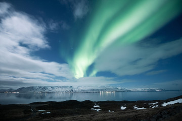 Wall Mural - Northern lights aurora borealis over Akureyri city in Iceland
