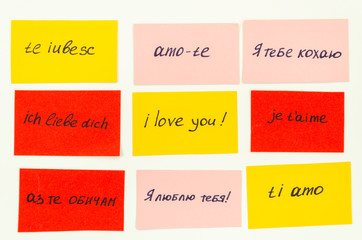 handwritten flashcards with a phrase i love you in different languages. learning new language concep