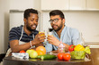 © liliyabatyrova - Male friends clinking glasses in kitchen
