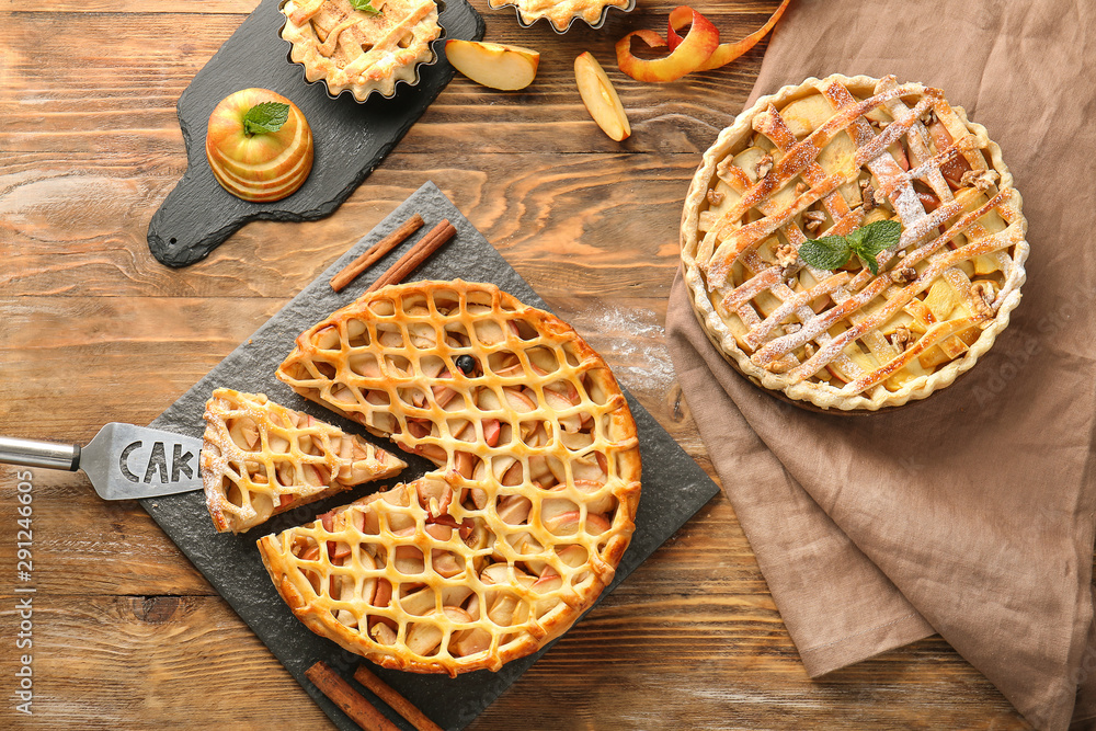 Tasty apple pies on wooden table