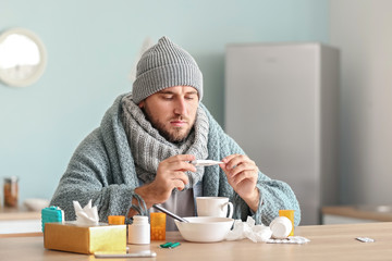 Sticker - Sick man measuring temperature at home