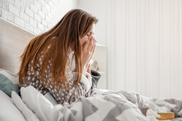 Sticker - Sick woman sitting on bed at home