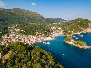 Wall Mural - Parga Greece drone aerial view. Crystal water natural landscape and beautiful architectural buildings near the port of Parga Epirus, Greece, Europe.