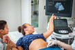 © Nejron Photo - Pregnant woman and her son on utltrasonographic examination at hospital