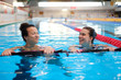 © Nejron Photo - Multiracial couple attending water aerobics class in a swimming pool