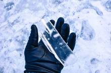 Holding A Thick Icicle With A Leather Glove