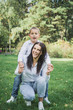 © bisonov - Eight year old son hugs mom in the park on the lawn