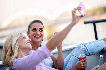 Wall Mural - Two girls having fun on rooftop.