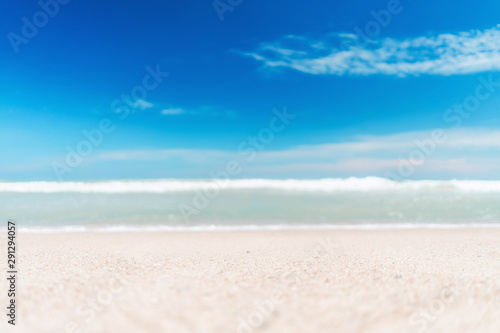 Blur tropical beach with bokeh sun light wave abstract background.