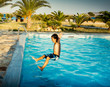 © bruno135_406 - Boy jumping into swimming pool