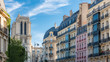 © Pascale Gueret - Paris, charming street and buildings, typical parisian facades in the Marais, with Notre-Dame cathedral in background