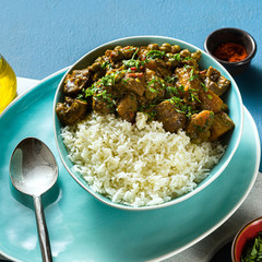 Wall Mural - vegetable curry with pumpkin and mushrooms. with rice on the table. healthy indian food. shot from above. copy space