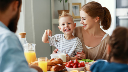 Wall Mural - family mother father and children have Breakfast in kitchen in morning.