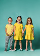 © FAB.1 - Triplets, brother and sisters. laughing and screaming loud have fun in the studio. full body shot of three children in bright clothes, two girls and one boy.