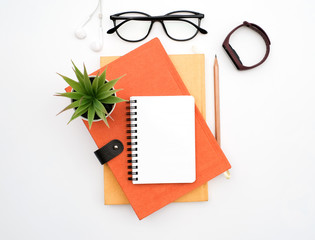 flat lay black to school and education concept on white table desk with blank notepad and stack of b