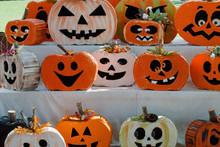 Pictures Of Various Pumpkin Carved Faces On Wood Themed Pumpkin.