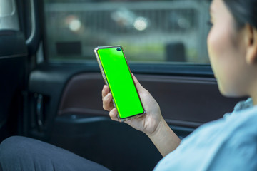 Female passenger using a phone with blank screen