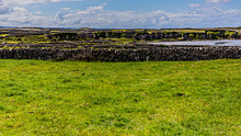 Limestone Fences In Irish Countryside On Island Of Inis Oirr, Beach And Horizon In Background, Sunny Spring Day With A Blue Sky And White Clouds At Inisheer, Small Island Off The West Coast Of Ireland