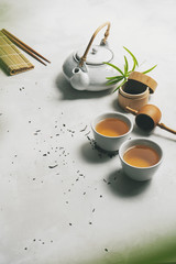 Wall Mural - Asian food concept with Tea set, chopsticks, bamboo mat, on white background for your own design. .