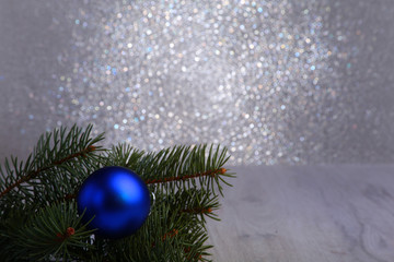 Wall Mural - Decorative background with fir branches and blue balls on the silver. Christmas card Holiday Concept