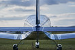 Detailed Picture of modern design ultralight airplane rear tail, elevator, rudder,wings and landing gear made by steel and aluminium in the sunny summer evening on the grass airfield in Czech republic