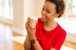 © Krakenimages.com - Beautiful young african american woman drinking a coffee in a take away paper cup