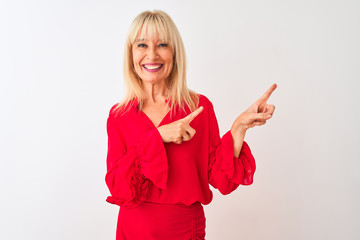 Wall Mural - Middle age businesswoman wearing elegant shirt standing over isolated white background smiling and looking at the camera pointing with two hands and fingers to the side.