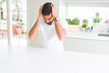 Sticker - Handsome hispanic man casual white t-shirt at home suffering from headache desperate and stressed because pain and migraine. Hands on head.