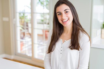 Poster - Beautiful young brunette woman smiling cheerful looking at the camera with a big smile on face showing teeth