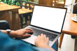 © Farknot Architect - Mockup image of a woman using and typing on laptop keyboard with blank white desktop screen